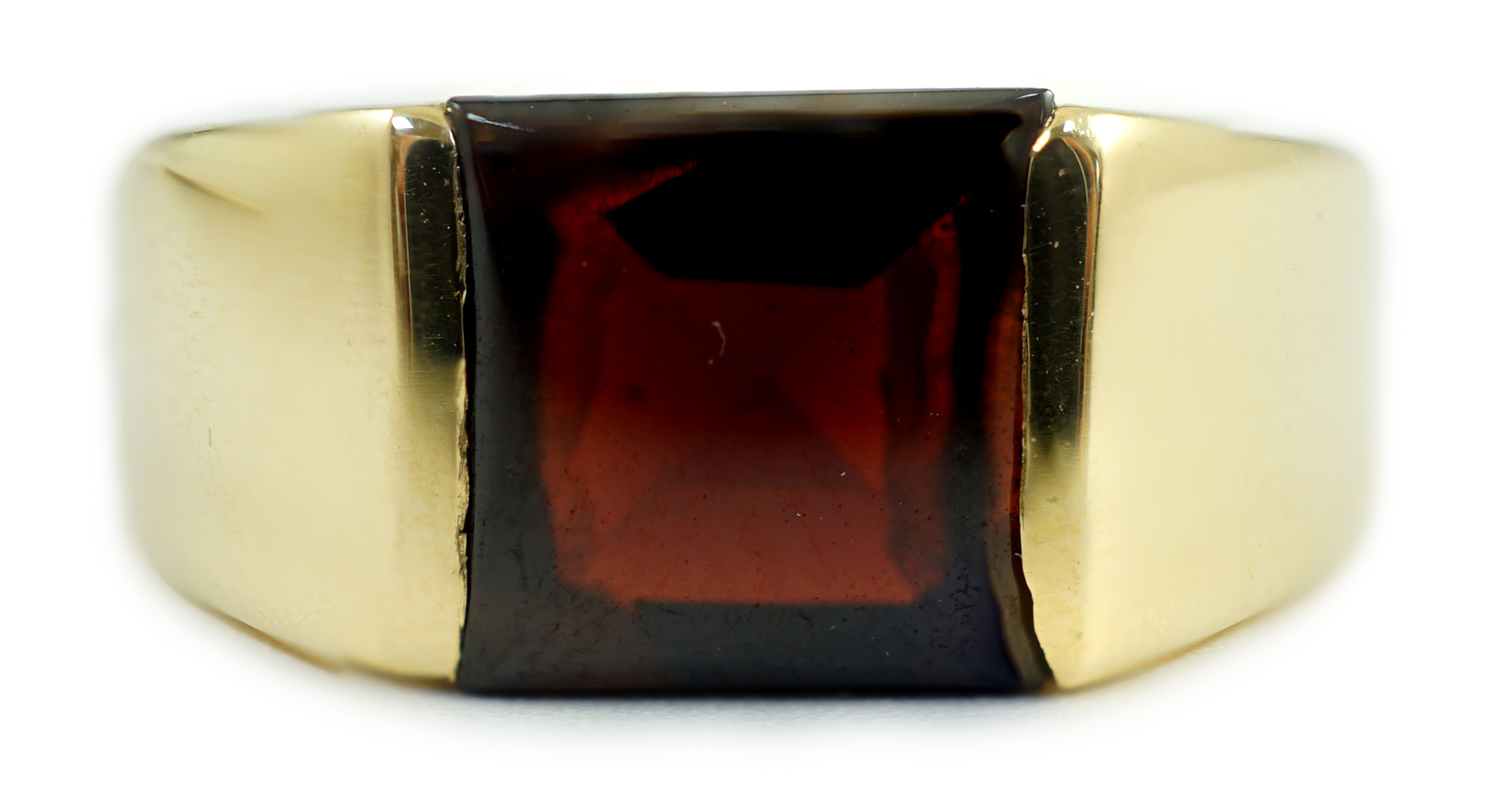 A gentleman's 1990's Cartier 18ct gold and gypsy set garnet ring